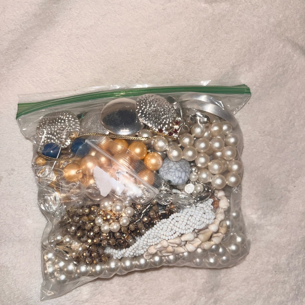 Bag of vintage jewelry. Contains rings, necklaces, bracelets, and earrings.